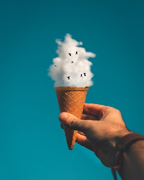 Hand holding sugar cone with cloud for ice cream and birds for peanuts 